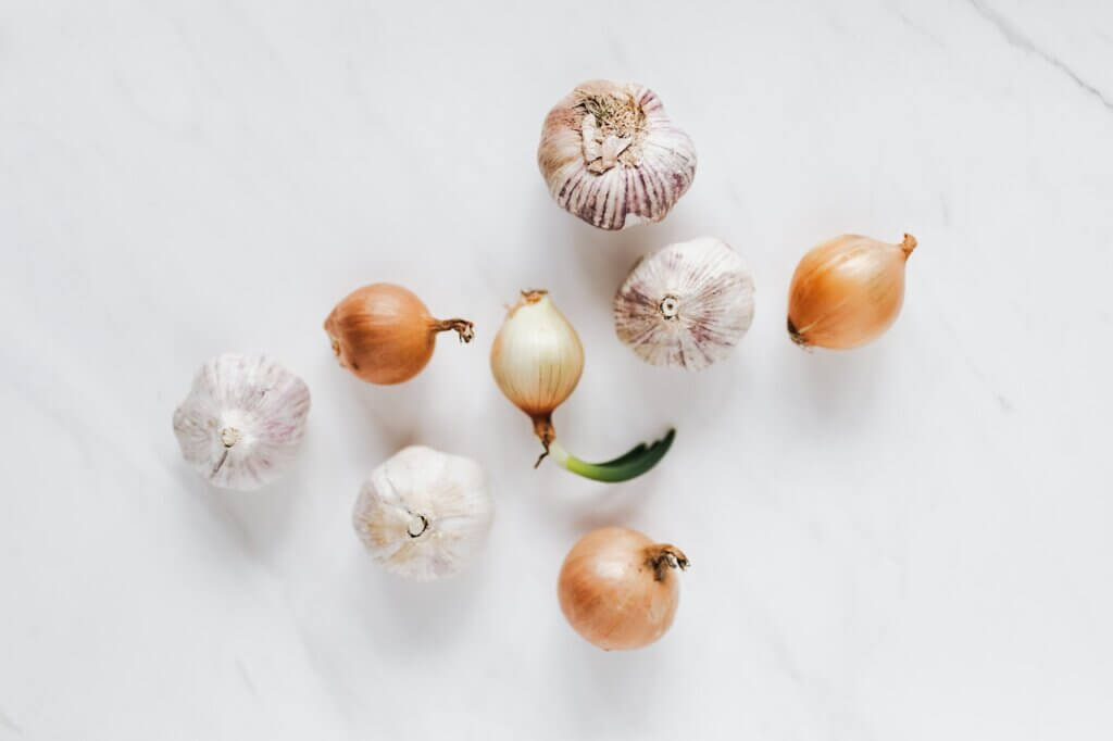 Onions and bulbs of garlic on a white background