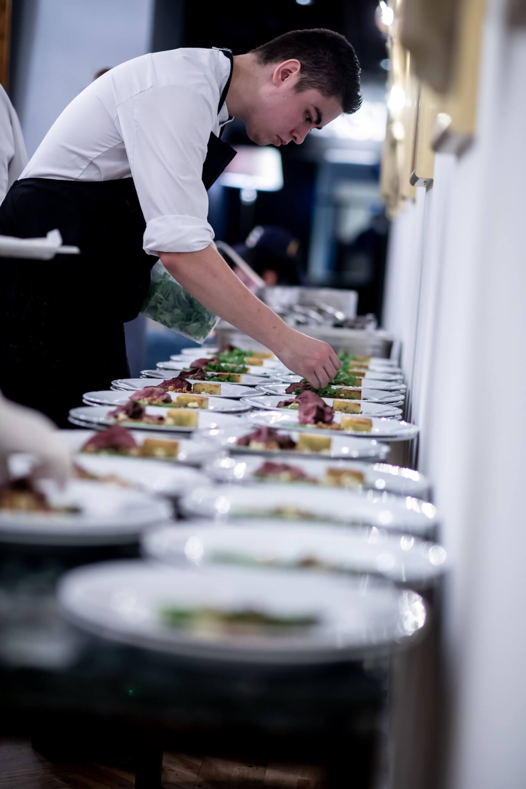 Chef plating food for a business dinner