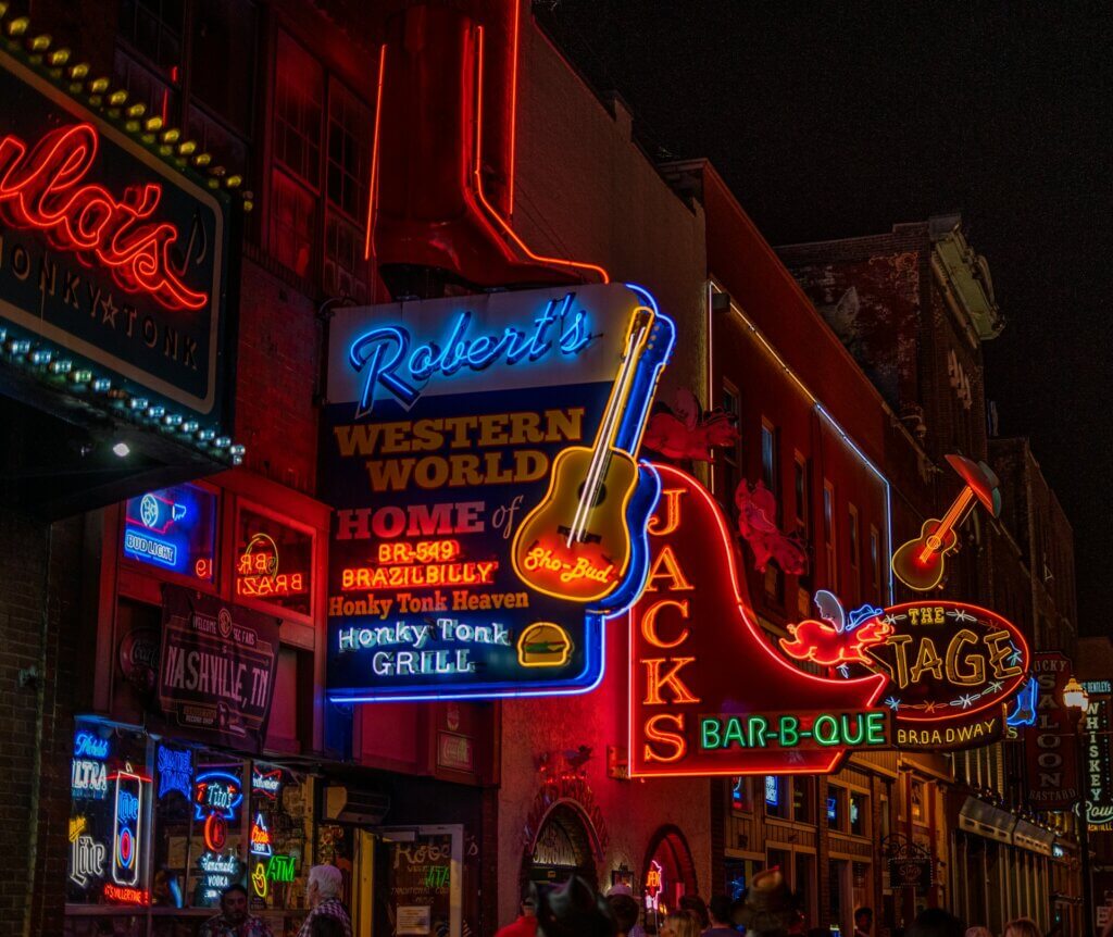 Neon signs hanging above a street in Nashville